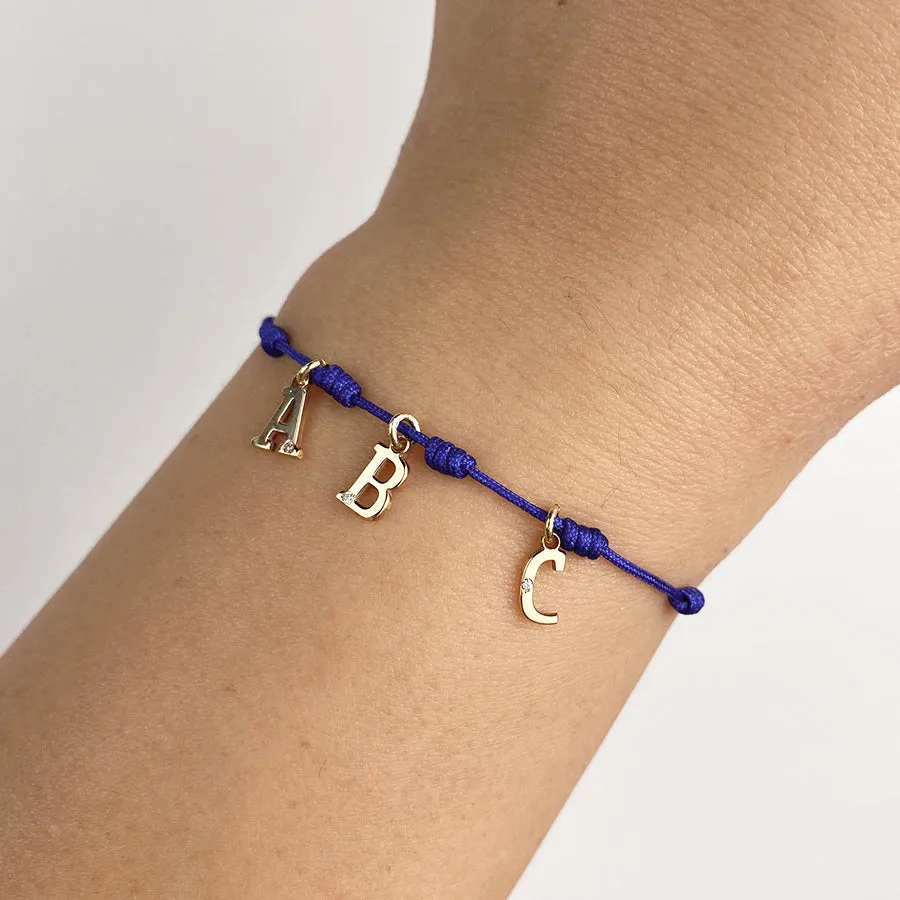 Pulsera con Inicial 7 nudos Azul 3 letras con Diamante y Oro