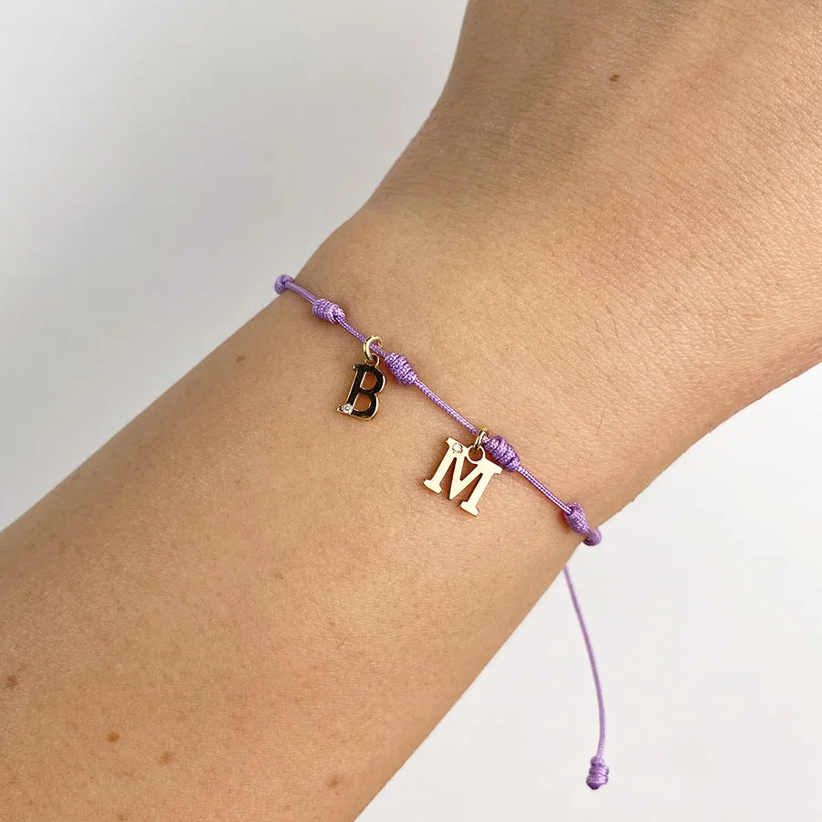 Pulsera con Inicial 7 nudos Lila 2 letras con Diamante y Oro