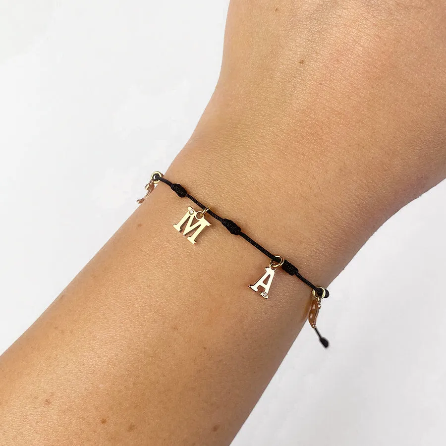 Pulsera con Inicial 7 nudos Negro 4 letras con Diamante y Oro